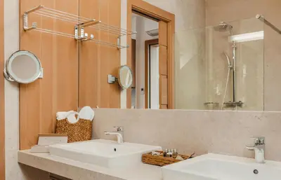 a bathroom with a white sink and a mirror at Boutique Skipass Superior Hotel in Kranjska Gora