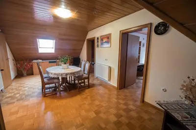 a dining room with a table and chairs at Apartment Tina with Seasonal Pool in Podsreda