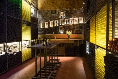 a bar with a table and chairs in a room at Turistična kmetija HLEBEC in Kog
