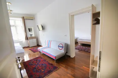 a living room with a couch and a bed at Hotel Vila Katrca in Ljubljana