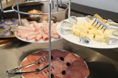 a bunch of different types of food on plates at Hotel Vila Katrca in Ljubljana