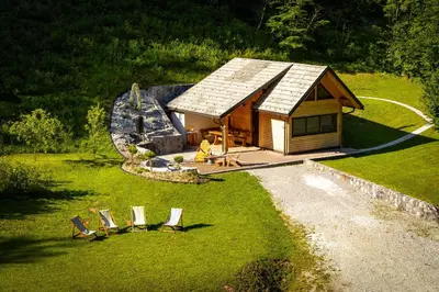an aerial view of a cabin with chairs in the grass at Chalet Letnik in Žiri