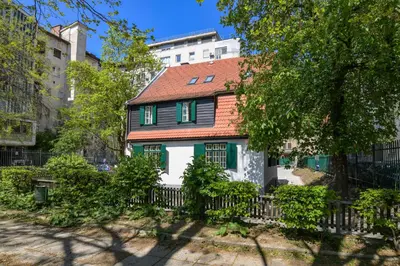 a house with a red roof and green windows at Vila Selena in Ljubljana