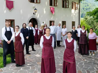 a group of people standing in front of a building at Kendov Dvorec in Spodnja Idrija