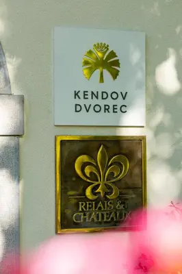 a sign on a wall with a kernrowvoyvoyore sign on it at Kendov Dvorec in Spodnja Idrija