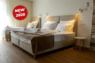 a bedroom with two beds with a sign that reads new at Bed & Breakfast Adelsberg Inn in Postojna