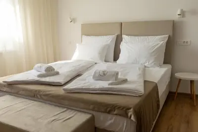 a bed with towels and pillows on top of it at Bed & Breakfast Adelsberg Inn in Postojna