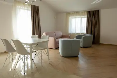 a living room with a table and chairs and a couch at Bed & Breakfast Adelsberg Inn in Postojna