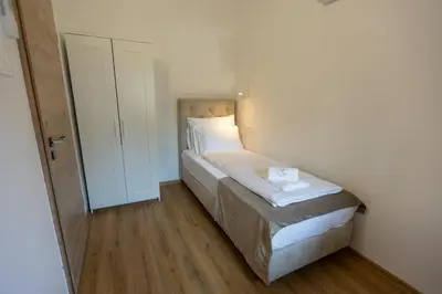 a small bedroom with a bed in a room at Bed & Breakfast Adelsberg Inn in Postojna