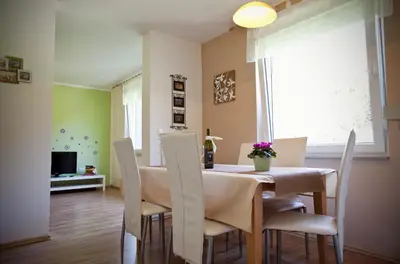 a dining room with a table and chairs at Apartments Soča in Kobarid