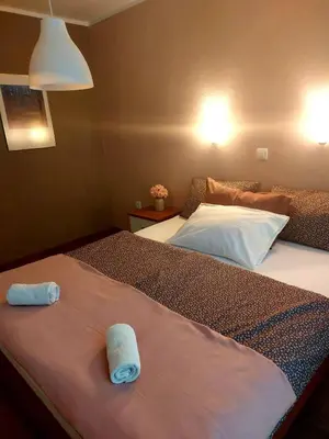 a bedroom with two beds with towels on them at Sobe ob Sotočju Budič Čatež ob Savi in Brežice