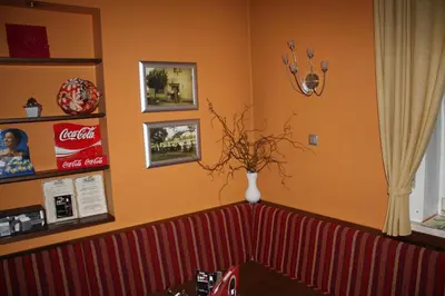 a living room with a vase of flowers on the wall at Sobe ob Sotočju Budič Čatež ob Savi in Brežice