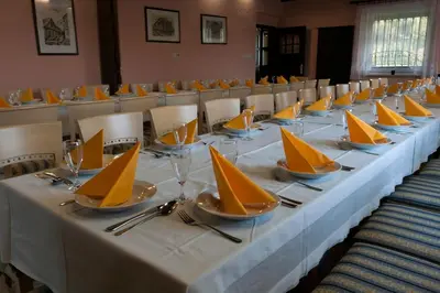 a long table with yellow napkins and plates on it at Pod Orehi Guest House in Loče pri Poljčanah