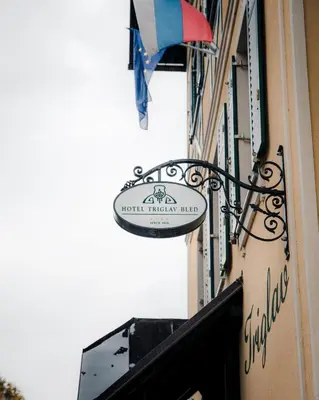 a sign on the side of a building at Hotel Triglav in Bled