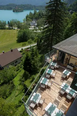 an aerial view of a deck with chairs and tables at Hotel Triglav in Bled