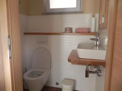 a small bathroom with a toilet and a sink at Apartments Vesna in Bled