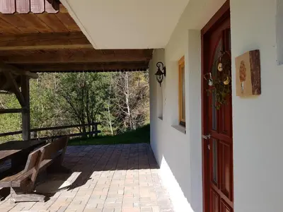 an open door of a house with a patio at Vaznik Farm House Apartments in Bled