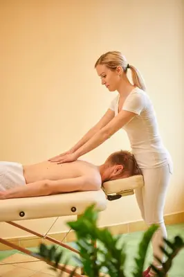 a woman is giving a man a massage at Eco Tourist Farm Ravnjak in Slovenj Gradec
