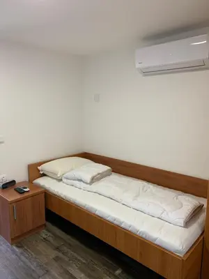 a bed in a room with a wooden frame at Apartman Decorus in Maribor