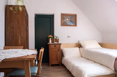 a living room with a couch and a table at Beekeeping Kojek in Ribnica