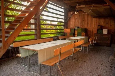 a room with tables and chairs in a barn at Beekeeping Kojek in Ribnica