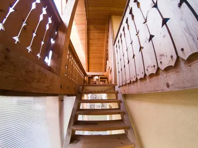 a staircase in a cabin with wooden walls and ceilings at Beekeeping Kojek in Ribnica