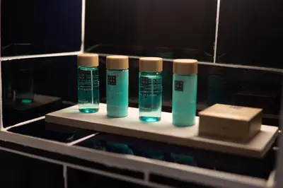 a group of four bottles of toothbrushes on a shelf in a bathroom at Hotel Starkl - Heritage & Unique in Bled