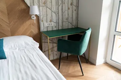 a bedroom with a desk and a chair next to a bed at Hotel Starkl - Heritage & Unique in Bled