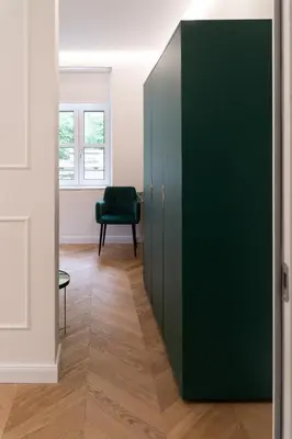 a green cabinet in a room with a chair at Hotel Starkl - Heritage & Unique in Bled