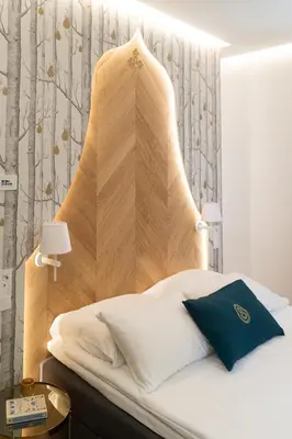 a bedroom with a bed with a wooden headboard at Hotel Starkl - Heritage & Unique in Bled