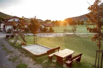 a park with a picnic table and a playground at EkoTurizem Hudičevec in Postojna