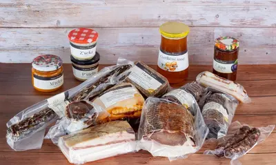 a table topped with different types of bread and condiments at EkoTurizem Hudičevec in Postojna