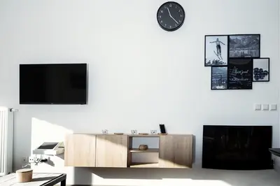 a living room with a tv on a white wall at Apartment Obsidian & Pearl in Kranjska Gora