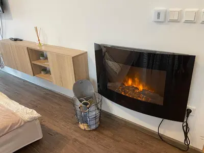 a fireplace in the corner of a room at Apartment Obsidian & Pearl in Kranjska Gora