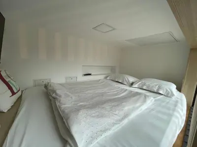a large white bed in a white room at Apartment Obsidian & Pearl in Kranjska Gora