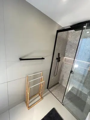a shower with a glass door in a bathroom at Apartment Obsidian & Pearl in Kranjska Gora
