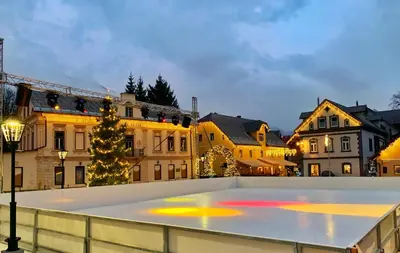 a rink in the middle of a city at night at Apartment Obsidian & Pearl in Kranjska Gora