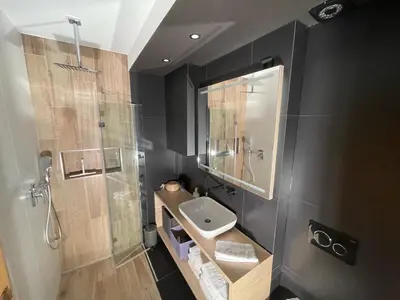 a bathroom with a sink and a shower at Apartment Obsidian & Pearl in Kranjska Gora