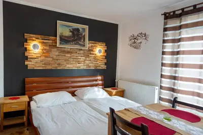 a bedroom with a bed and a brick wall at Apartments Silva in Ljutomer