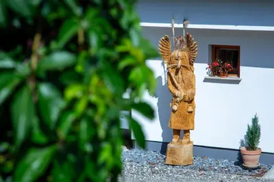 a statue of an angel in front of a building at Apartments Silva in Ljutomer