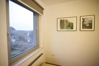 a window in a room with two pictures on the wall at Primula Accommodation in Nova Gorica