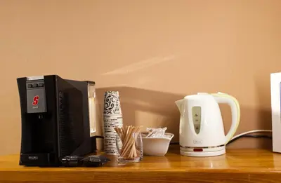 a counter top with a coffee maker and a microwave at Primula Accommodation in Nova Gorica