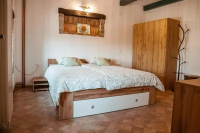 a bedroom with a bed with two pillows on it at Mulberry house in Šempas