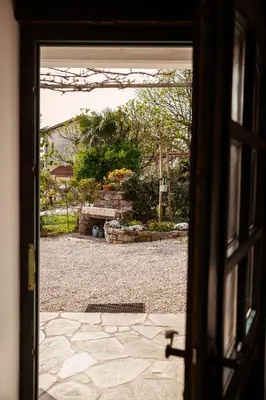 an open door with a view of a yard at Mulberry house in Šempas