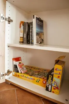 a shelf with books and a box on it at Mulberry house in Šempas