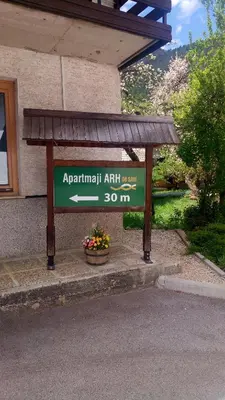 a sign in front of a building at Apartments Arh in Bohinj
