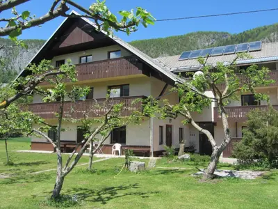 a house with solar panels on the roof at Apartments Arh in Bohinj