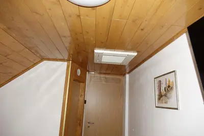 a hallway with a wooden ceiling and a door at BOOA Rooms Irena in Bohinj