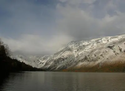 a view of a snow covered mountain with a lake at BOOA Rooms Irena in Bohinj