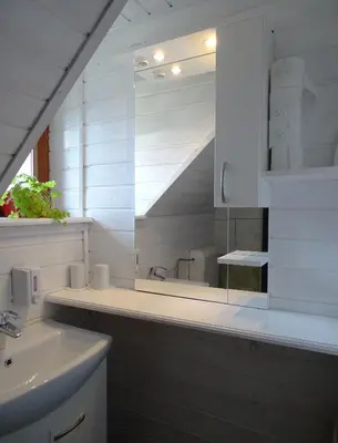a white bathroom with a sink and a mirror at Apartments Zorč in Bohinj